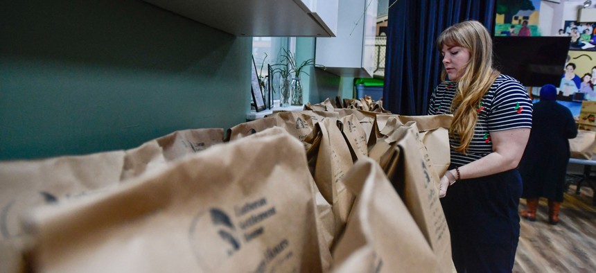 Volunteers at the Lutheran Settlement House pack bags of groceries to distribute to the local community for their daily food pantry in Philadelphia, Pennsylvania, on Oct. 30. Starting on Nov. 1, Supplemental Nutrition Assistance Program benefits are set to lapse, impacting millions of Americans amid the government shutdown.