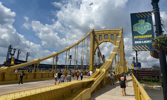 NFL fans cross the Roberto Clemente Bridge during Draft Week in Pittsburgh.