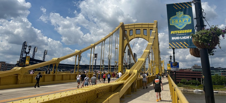 NFL fans cross the Roberto Clemente Bridge during Draft Week in Pittsburgh.
