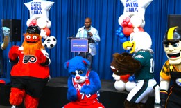 Philadelphia 2026 director Michael Newmuis and local sports mascots take part in a Pennsylvania pep rally.