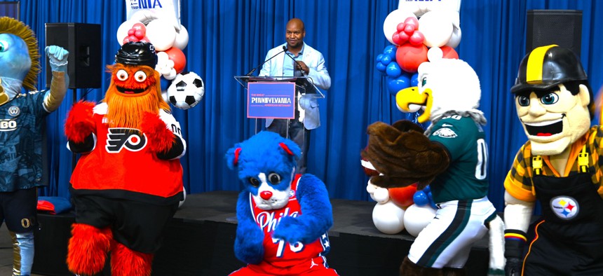 Philadelphia 2026 director Michael Newmuis and local sports mascots take part in a Pennsylvania pep rally.
