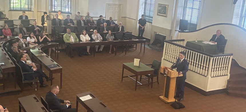 U.S. Rep. Brendan Boyle speaks at the lectern during a ceremonial gathering of members of Congress at Congress Hall in Philadelphia. Seated behind him is U.S. Rep Glenn Thompson, the chair of the session.