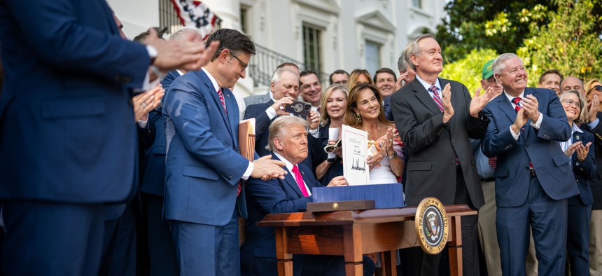 President Donald Trump signs the One Big Beautiful Bill Act into law on July 4, 2025.
