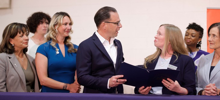Gov. Josh Shapiro speaks with YWCA Carlisle & Cumberland County Board Member Andrea Greene at a ceremonial bill signing.