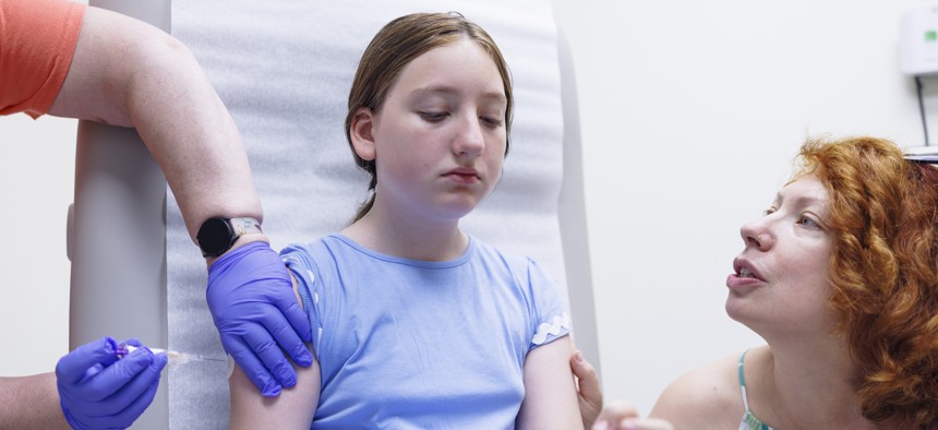 A young patient gets vaccinated at a family medicine clinic in the Poconos.