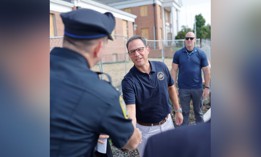 Gov. Josh Shapiro shakes hands with a police officer during an event in Montgomery County.