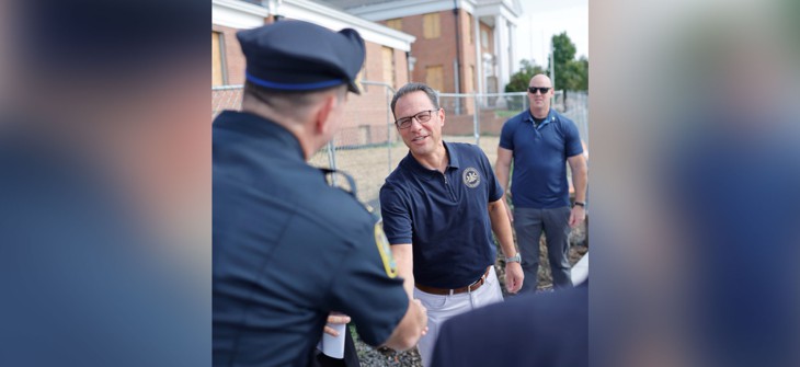 Gov. Josh Shapiro shakes hands with a police officer during an event in Montgomery County.